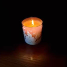 Load image into Gallery viewer, Candle in a glass holder on a dark background. halloween themed
